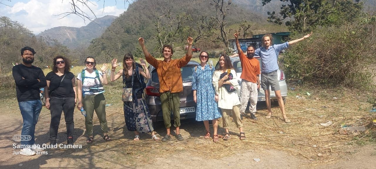 A group of international guests standing together at Junegiri Farms after arriving